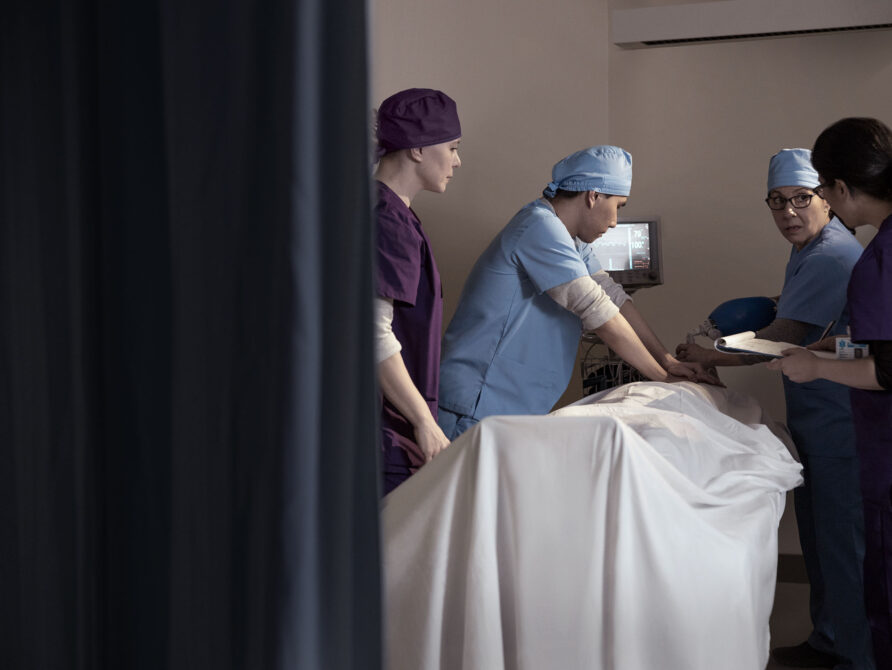 Doctors with patient in operating room