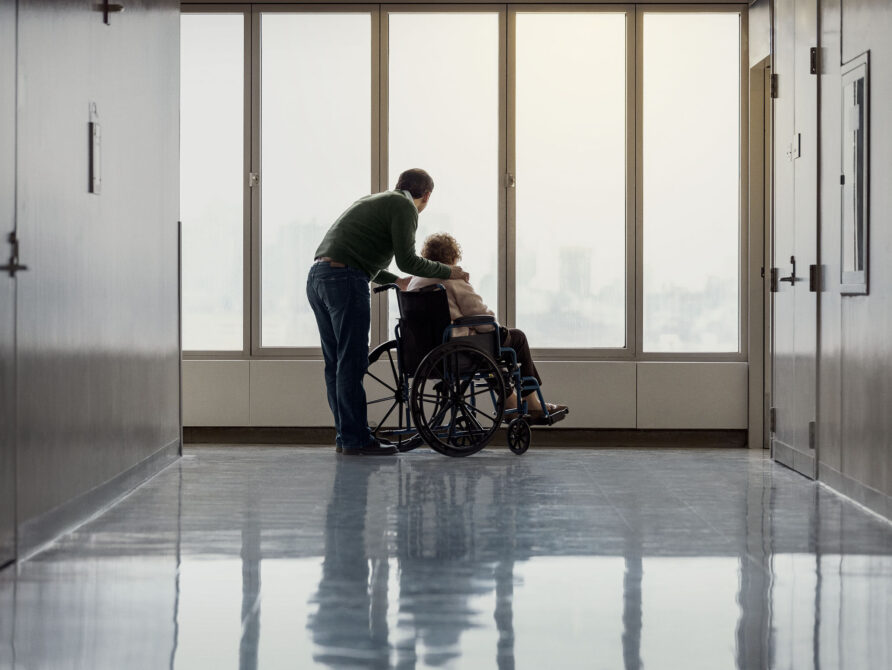 Individual pushing another individual in a wheelchair