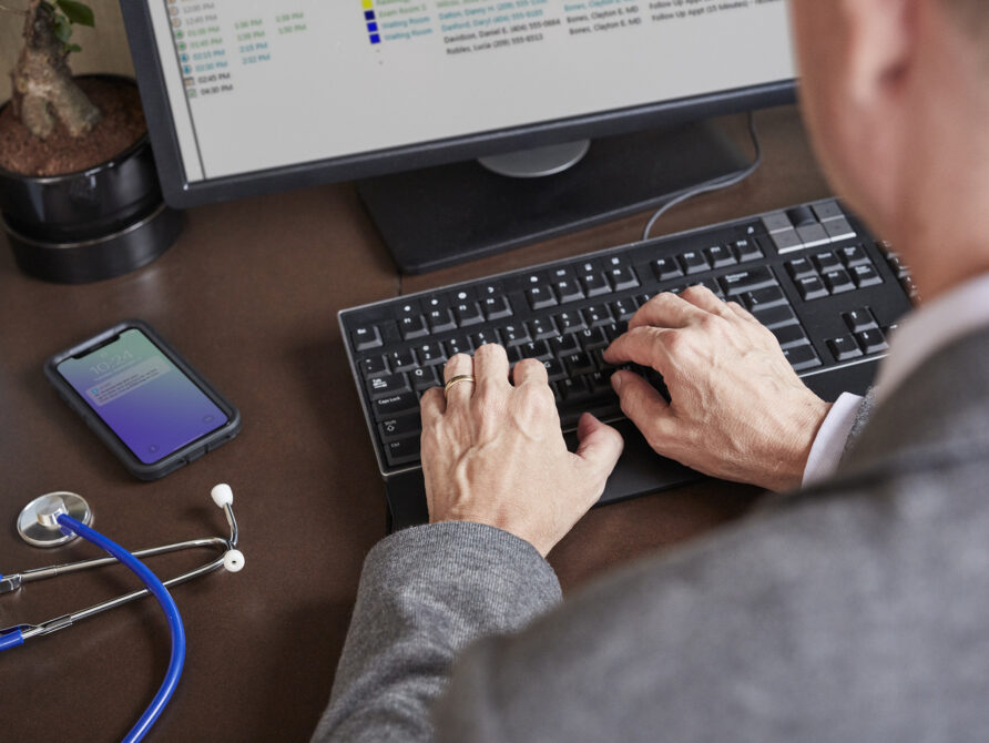 Image of individual using an EHR tool on the computer