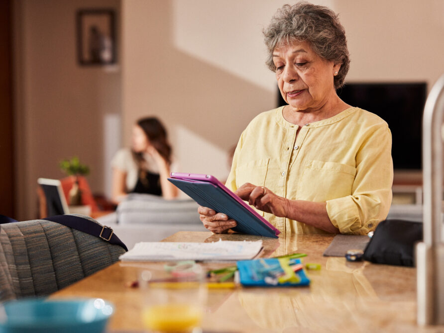 Image of elderly woman using EHR tool on tablet
