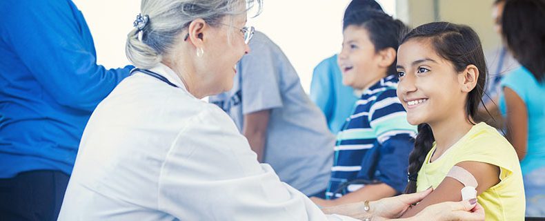 Doctor giving immunization to young patient