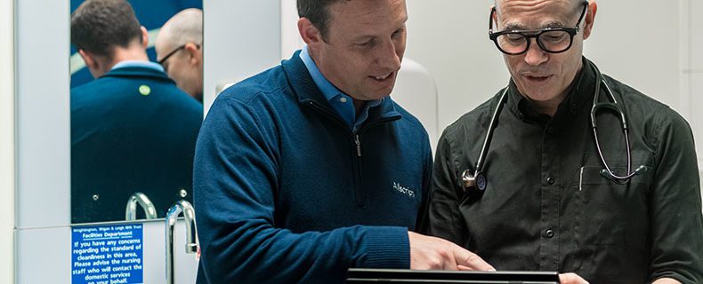 Nurse and doctor looking at EHR app