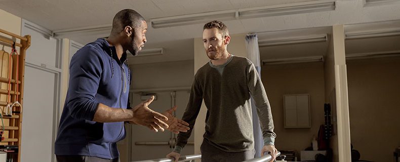 Individual helping patient with rehab.