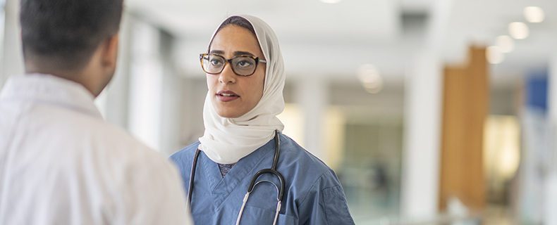 Female doctor discussing with male doctor