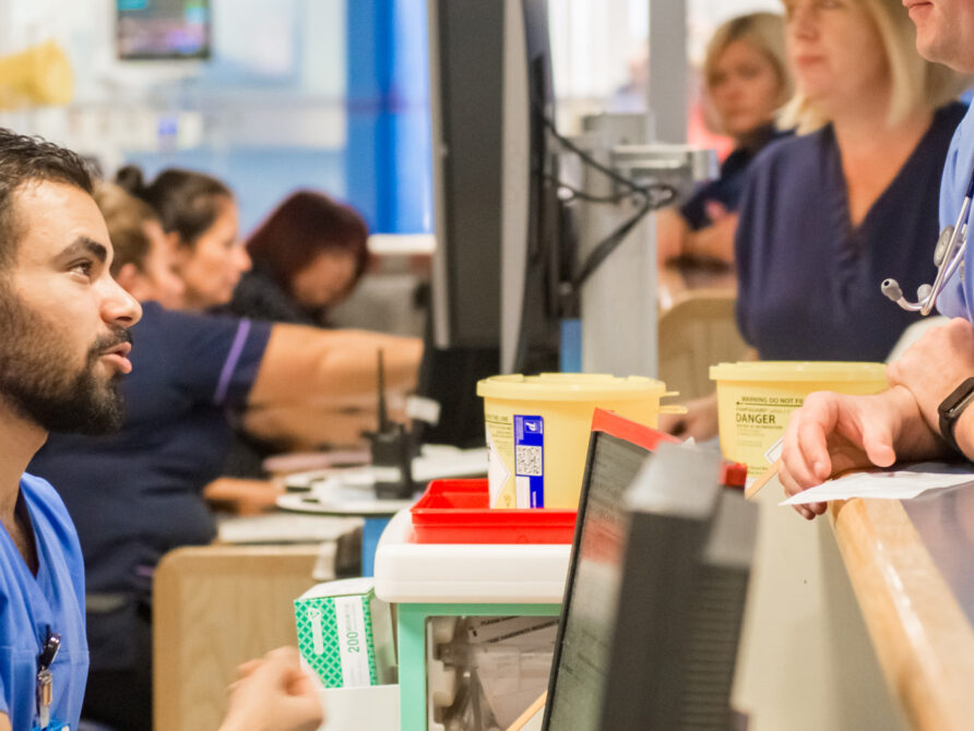 Nurses and doctors discussing patient care.