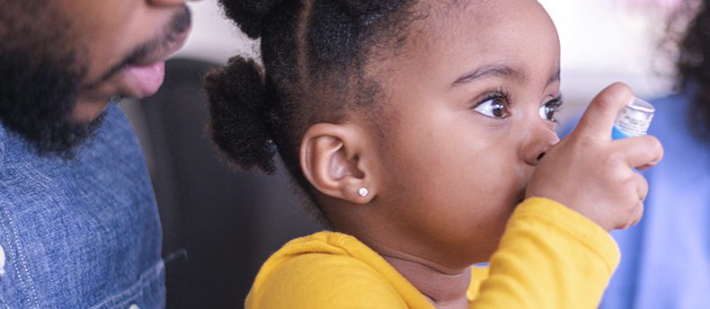 Child using inhaler at doctor's office.