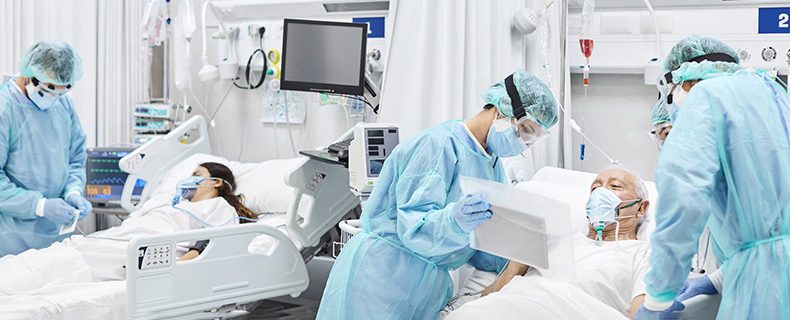 Doctors and nurses taking care of patients in ICU.