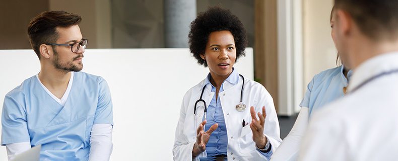 Doctors and nurse in a meeting together.