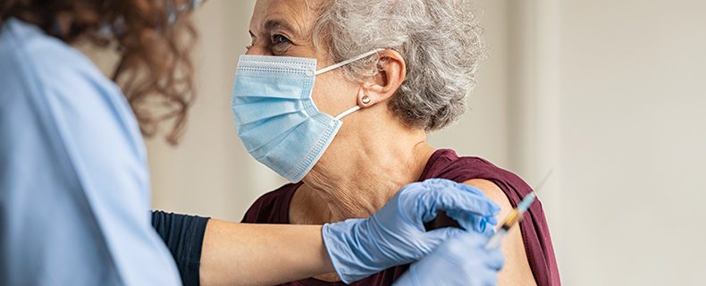 woman recieves covid-19 vaccine