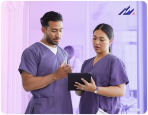 Two nurses looking at EHR on tablet.