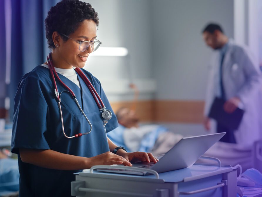 Nurse using EHR tool on laptop.