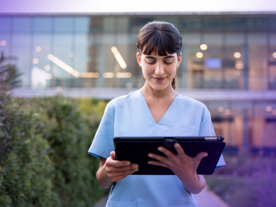 Nurse looking at EHR software on tablet