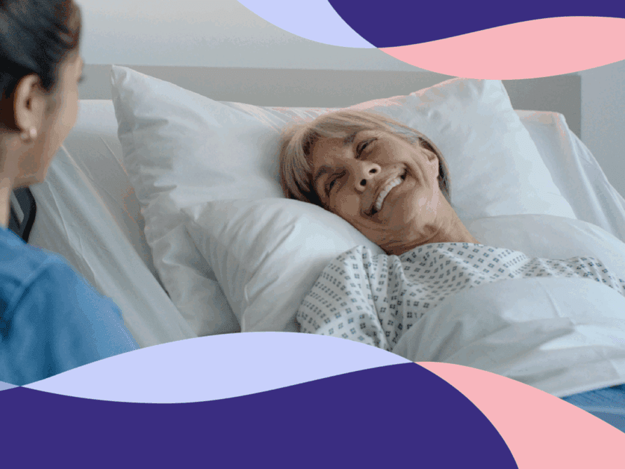 Nurse talking to patient in hospital bed